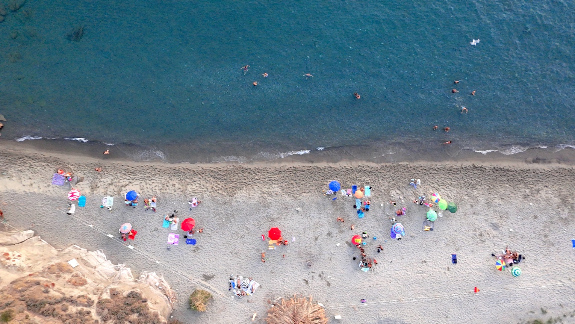 People on Cava Dell'Isola Beach at Sunset